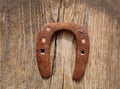 Antique horseshoe luck symbol rusted on vintage wood Royalty Free Stock Photo