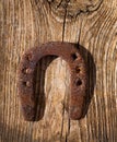 Antique horseshoe luck symbol rusted on vintage wood Royalty Free Stock Photo