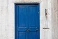 Antique blue door and old bell on wall Royalty Free Stock Photo