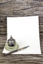Antique ink pen and inkwell and old paper Royalty Free Stock Photo