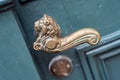 Antique iron bronze brass handle in the shape of a lion on a blue door. Antique, Vintage decoration on the door Royalty Free Stock Photo