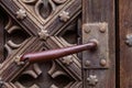 antique iron handle on the background of wooden door Royalty Free Stock Photo