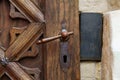 antique iron handle on the background of wooden door Royalty Free Stock Photo