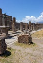 Antique italian square with ruins and columns and monument in Pompeii, Italy. Ancient forum concept.