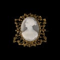 Antique brooch with a female profile in a gold frame. antique brooch on a black isolated background Royalty Free Stock Photo