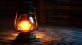 Antique kerosene lamp, lit, on bamboo mat, dark background Royalty Free Stock Photo