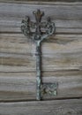 Antique key with the cross figure on vintage wooden