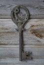 Antique key with the figure of arabic letter waw on vintage wooden