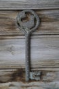 Antique key with the figure of Shahmaran Queen of Snakes on vintage wooden