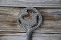 Antique key with the figure of Shahmaran Queen of Snakes on vintage wooden
