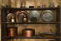 Antique kitchenware collection on wooden shelf, Metal utensils ,pans, containers ,pots made of copper,brass,stainless steel and Royalty Free Stock Photo