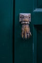 antique knock door shape hand on green door. Southern Italy Royalty Free Stock Photo