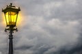 An antique lamp against storm clouds Royalty Free Stock Photo