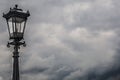 An antique lamp against storm clouds Royalty Free Stock Photo