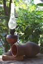 Antique lamp jug and an old book on the background of the garden Royalty Free Stock Photo