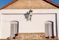 Antique lamp post on brick wall with two closed windows. Old house Royalty Free Stock Photo