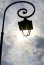 Antique lamp post with Sun shining through the lantern Royalty Free Stock Photo