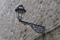 Antique lamppost lantern attached to medieval wall of castle. Light off