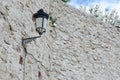 Antique lantern lamp on the stone wall outside. Nostalgic vintage background with copy space Royalty Free Stock Photo