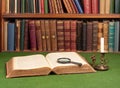 Antique leather books, tin candlestick and magnifying Royalty Free Stock Photo