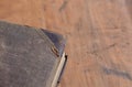 Antique leather bound book laying on an old rustic wood