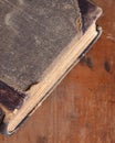 Antique leather bound book laying on an old rustic wood