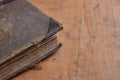 Antique leather bound book laying on an old rustic wood