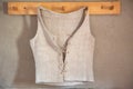 Antique linen undershirt hanging on wardrobe at wall