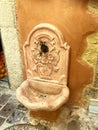 Antique marble water fountain on a stone wall in the historic center of Creta, Chania, Greece at 10 August 2023 Royalty Free Stock Photo