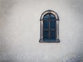 Antique medieval window with iron bars and old white wall Royalty Free Stock Photo