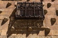 Antique medieval wrought iron balcony and shell moldings with their elongated shadows from the evening sun on the facade of La Royalty Free Stock Photo