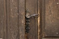 Antique metal door handle on old wooden doors. Vintage iron door knob Royalty Free Stock Photo