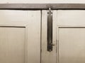 Antique metal door latch on the old wooden door. Royalty Free Stock Photo