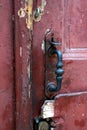 Antique metal doorhandle on an old shabby wooden door Royalty Free Stock Photo