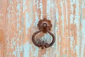 An antique metal handle on a wooden door.