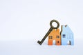 Antique metal key on color wooden miniature house Royalty Free Stock Photo