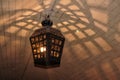 an antique metal lantern hangs from the ceiling. The vaulted ceiling of the basement, the light from the lantern through