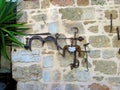 Antique metal objects are hanging on a stone wall. Royalty Free Stock Photo