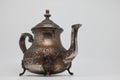 Antique metal teapot on a white background. Close-up of an old Arabic teapot. Royalty Free Stock Photo