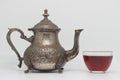 Antique metal teapot on a white background. Close up of an old Arabic teapot. A cup of tea. Royalty Free Stock Photo