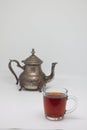 Antique metal teapot on a white background. Close up of an old Arabic teapot. A cup of tea. Royalty Free Stock Photo