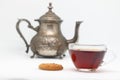 Antique metal teapot on a white background. Close up of an old Arabic teapot. A cup of tea. Royalty Free Stock Photo