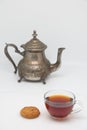 Antique metal teapot on a white background. Close up of an old Arabic teapot. A cup of tea Royalty Free Stock Photo