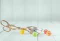 Antique metal tongs and round colorful candies