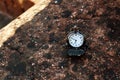 Antique pocket watch on stone textured shelf