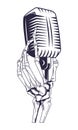 Antique microphone and skeleton hand