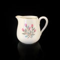 Antique milk jug with floral pattern. Royalty Free Stock Photo