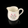 Antique milk jug with floral pattern. Royalty Free Stock Photo