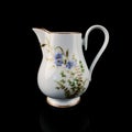 Antique milk jug with floral pattern. Royalty Free Stock Photo