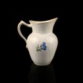 Antique milk jug with floral pattern. Royalty Free Stock Photo